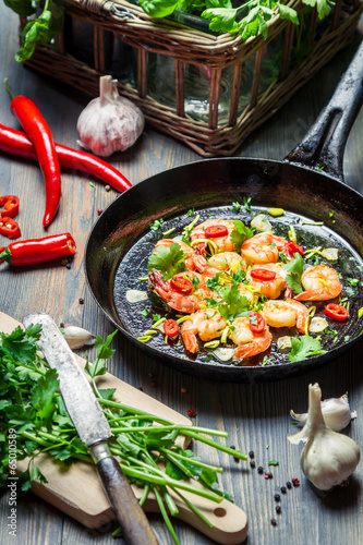 Photo: Shrimps served on a pan with fresh herbs Shrimps served on a pan with fresh herbs