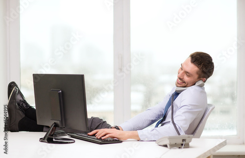 Photo: smiling businessman or student with computer smiling businessman or student with computer