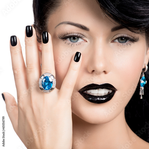 Photo: Glamour woman's nails , lips and eyes painted color black. Glamour woman's nails , lips and eyes painted color black.