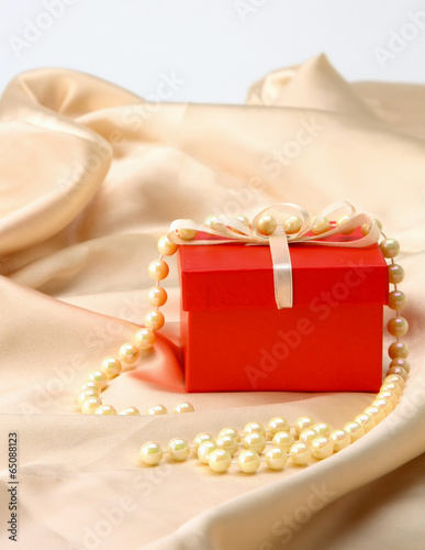 Photo: gift on red silk satin background gift on red silk satin background