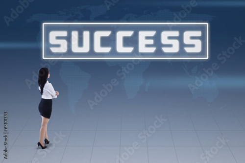 Photo: Businesswoman and success concept on blue world map Businesswoman and success concept on blue world map