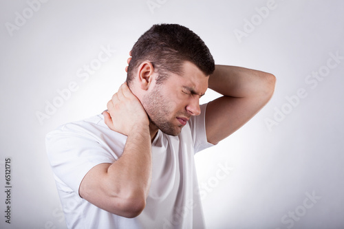 Photo: Man suffering from neck pain Man suffering from neck pain