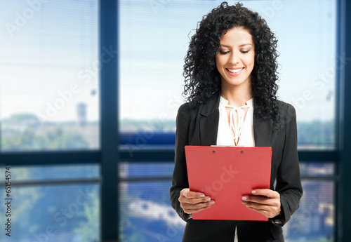 Photo: Woman reading a document Woman reading a document