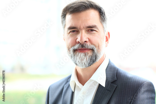 Photo: Portrait of a happy senior business man smiling Portrait of a happy senior business man smiling