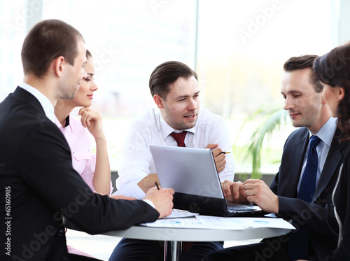 Photo: business partners discussing documents and ideas at meeting business partners discussing documents and ideas at meeting