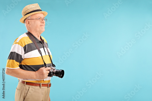 Photo: Senior gentleman with camera Senior gentleman with camera
