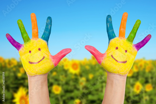 Photo: Two smiley hands in sunny summer's day. Two smiley hands in sunny summer's day.