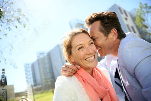 Photo: Portrait of mature loving couple enjoying sunny day Portrait of mature loving couple enjoying sunny day