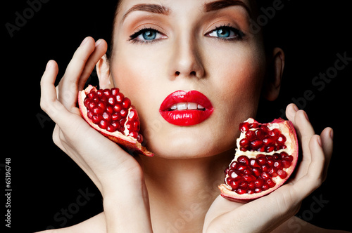 Photo: woman with Pomegranate. professional makeup woman with Pomegranate. professional makeup