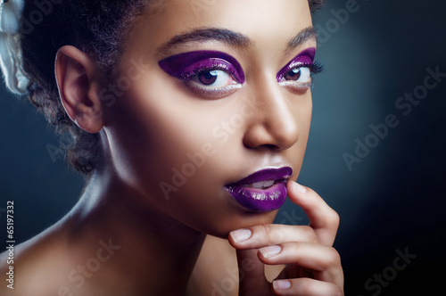 Photo: The portrait of beautiful young black girl in violet color The portrait of beautiful young black girl in violet color