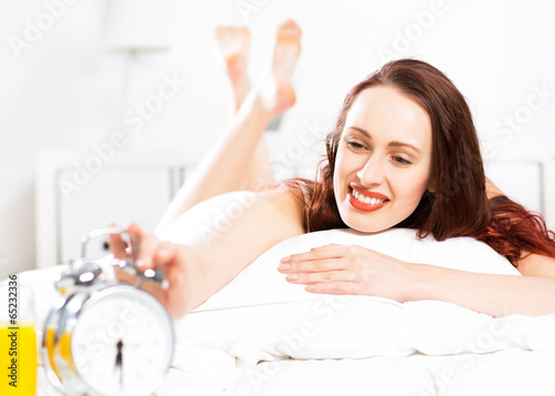 Photo: woman turns off the alarm woman turns off the alarm