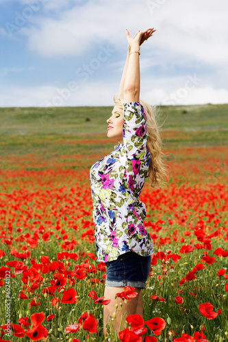 Photo: Beautiful girl on the poppy field Beautiful girl on the poppy field
