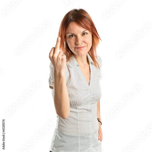 Photo: young girl making horn gesture over white background young girl making horn gesture over white background