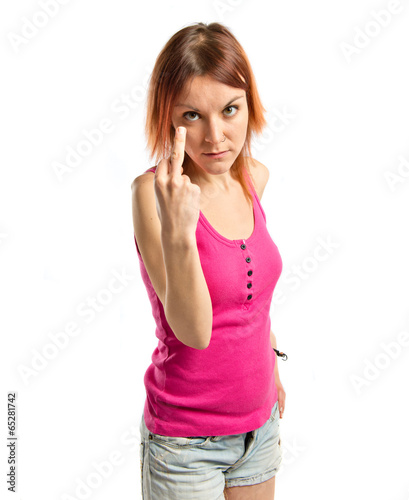 Photo: young girl making horn gesture over white background young girl making horn gesture over white background