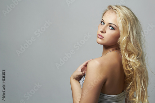 Photo: Beautiful blond woman.curly hairstyle.sexy girl with blue eyes Beautiful blond woman.curly hairstyle.sexy girl with blue eyes