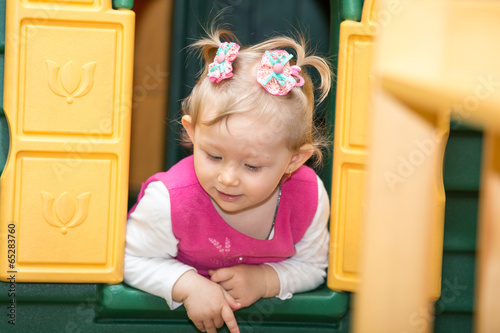 Photo: Little child girl playing in kindergarten in Montessori Little child girl playing in kindergarten in Montessori
