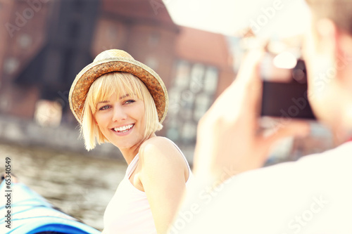 Photo: Couple taking pictures on kayaks Couple taking pictures on kayaks