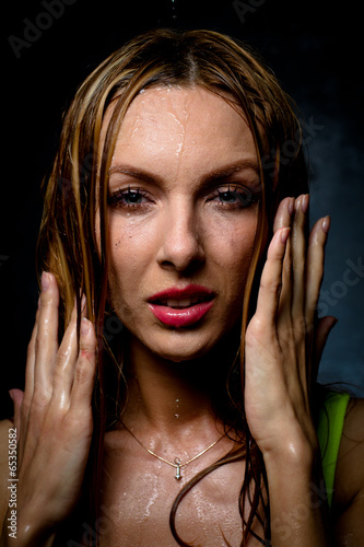 Photo: Wet girl on which water flows in a white cloth Wet girl on which water flows in a white cloth