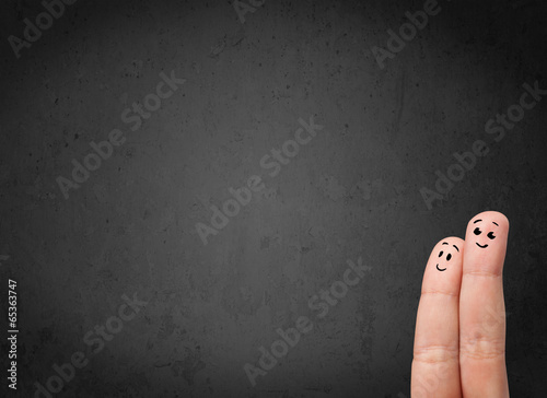 Photo: Happy finger smileys with empty copy space dark background Happy finger smileys with empty copy space dark background