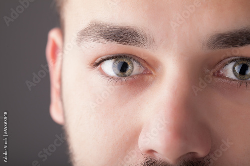 Photo: Portrait of a handsome man close up eye Portrait of a handsome man close up eye