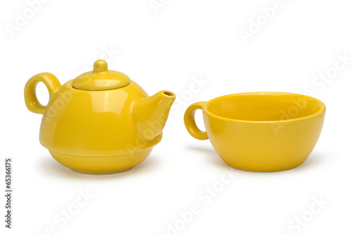 Photo: Set of a yellow ceramic teapot and mug isolated on a white backg Set of a yellow ceramic teapot and mug isolated on a white backg