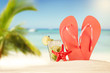 Summer beach with red sandals and shells Summer beach with red sandals and shells