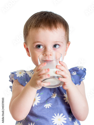 Photo: Kid drinking milk from glass isolated on white background Kid drinking milk from glass isolated on white background