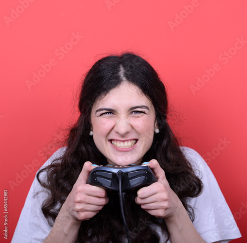 Photo: Portrait of girl holding game controller and playing games again Portrait of girl holding game controller and playing games again