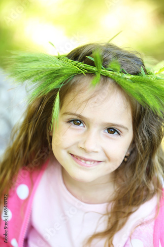 Photo: Happy little girl in the green park Happy little girl in the green park