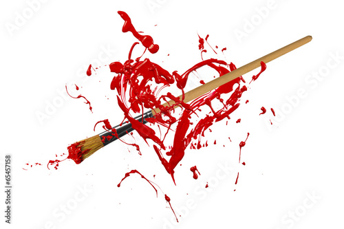 Photo: Red painted heart pierced by paintbrush Red painted heart pierced by paintbrush