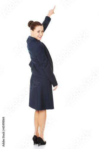 Photo: Business woman pointing on copy space. Business woman pointing on copy space.