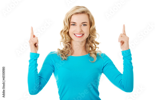 Photo: Woman pointing on copy space. Woman pointing on copy space.