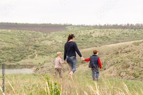 Photo: Mother walking with two boys in the countryside Mother walking with two boys in the countryside