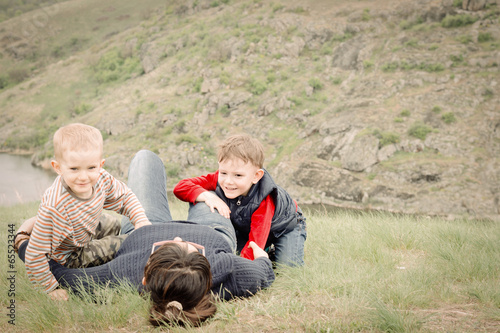 Photo: Two young boys playing with their mother Two young boys playing with their mother