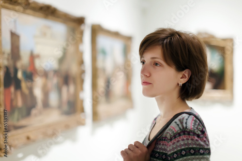 woman looking pictures in museum