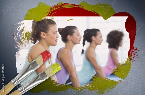 Photo: Composite image of yoga class in the gym Composite image of yoga class in the gym