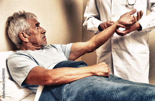 Photo: Pulse being taking on a middle aged man's wrist Pulse being taking on a middle aged man's wrist