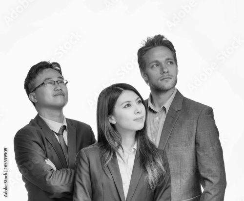 Photo: Mixed race business people looking far away Mixed race business people looking far away