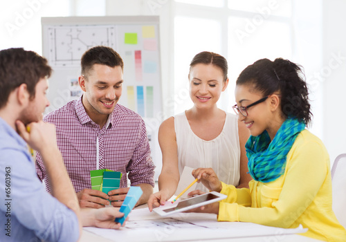 Photo: smiling interior designers working in office smiling interior designers working in office