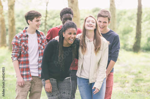 Photo: Multiethnic Group of Teenagers Walking at Park Multiethnic Group of Teenagers Walking at Park