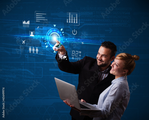 Photo: Young business couple touching future web technology buttons and Young business couple touching future web technology buttons and