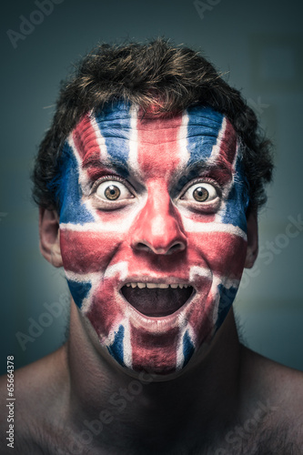 Photo: Shocked man with British flag painted on face Shocked man with British flag painted on face