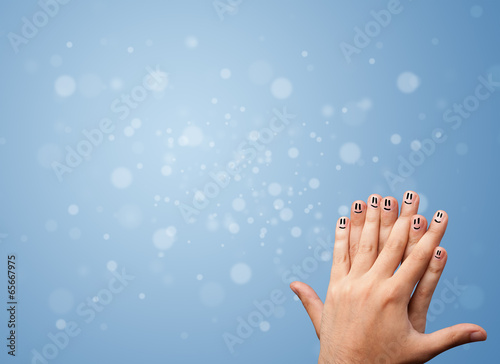 Photo: Happy finger smileys with empty blue bokeh background Happy finger smileys with empty blue bokeh background