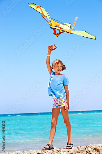 Photo: Kid flying kite outdoor. Kid flying kite outdoor.