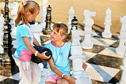 Photo: Children play chess outdoor. Children play chess outdoor.