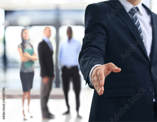 Photo: A business man with an open hand ready to seal a deal A business man with an open hand ready to seal a deal