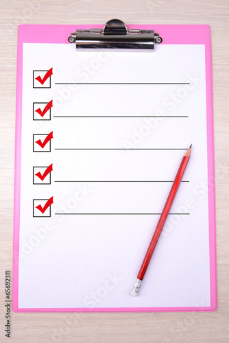 Photo: Clipboard on wooden background Clipboard on wooden background