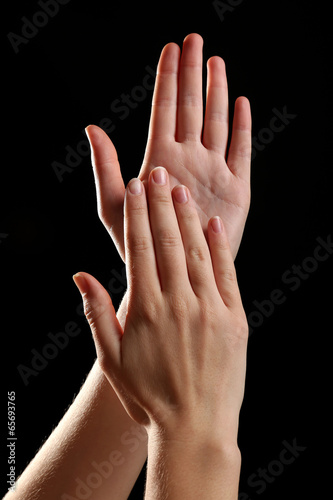 Photo: Human hands on black background Human hands on black background