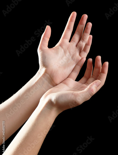 Photo: Human hands on black background Human hands on black background