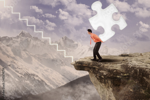 Photo: Businessman walk up with puzzle Businessman walk up with puzzle